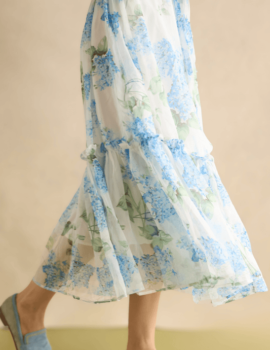 Floral dress with blue and green pattern on a plain background