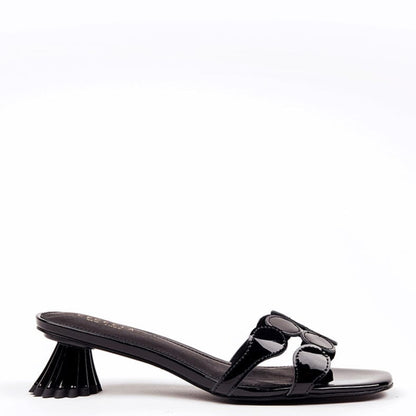 Black patent leather kitten heel sandal with circle toe strap and a distinctive heel design.