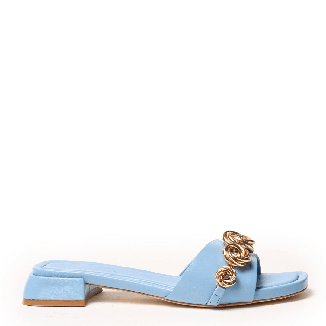 Soft blue sandal with gold rosette metal charms