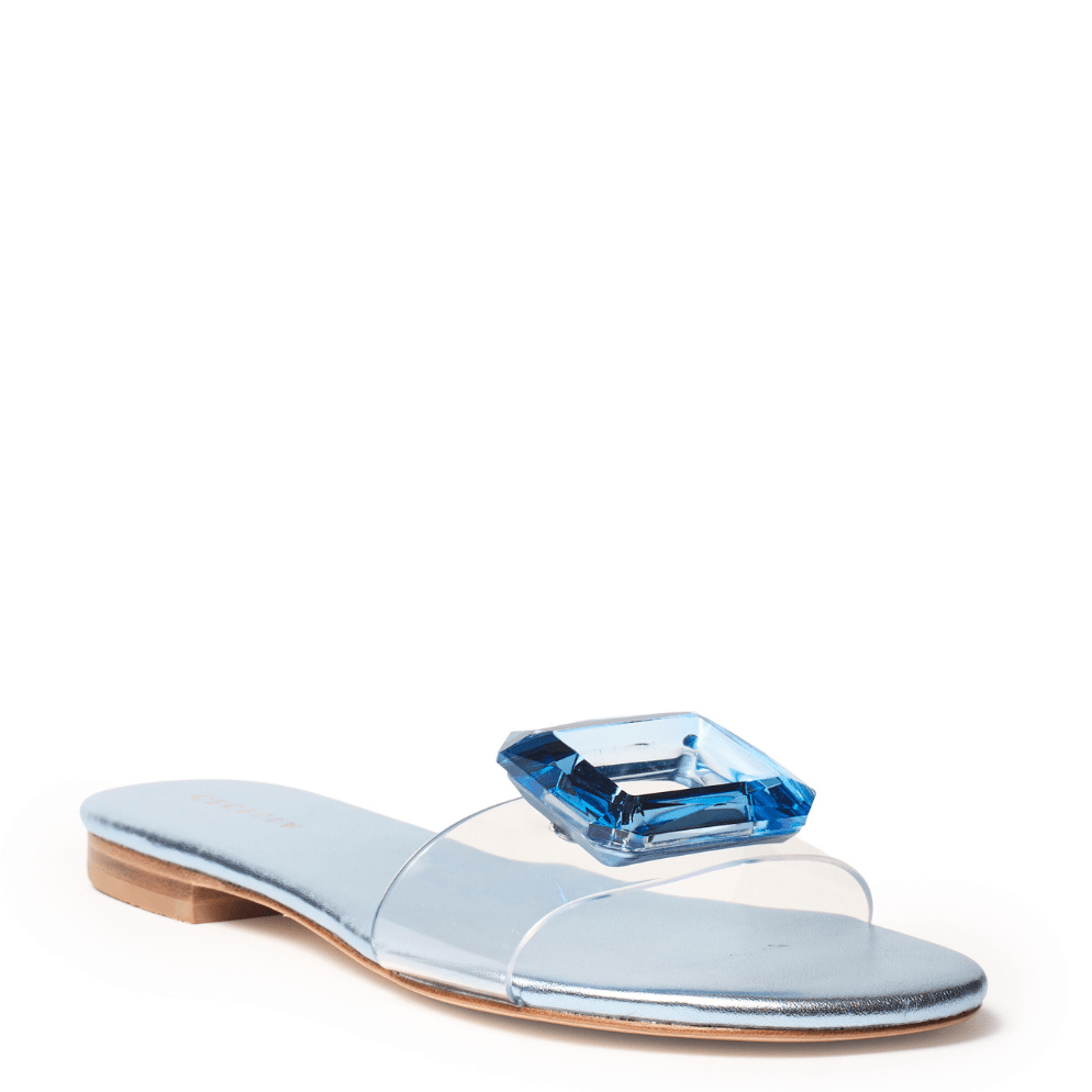 Light blue metallic sandal with a clear strap cushioned heel and blue jewel