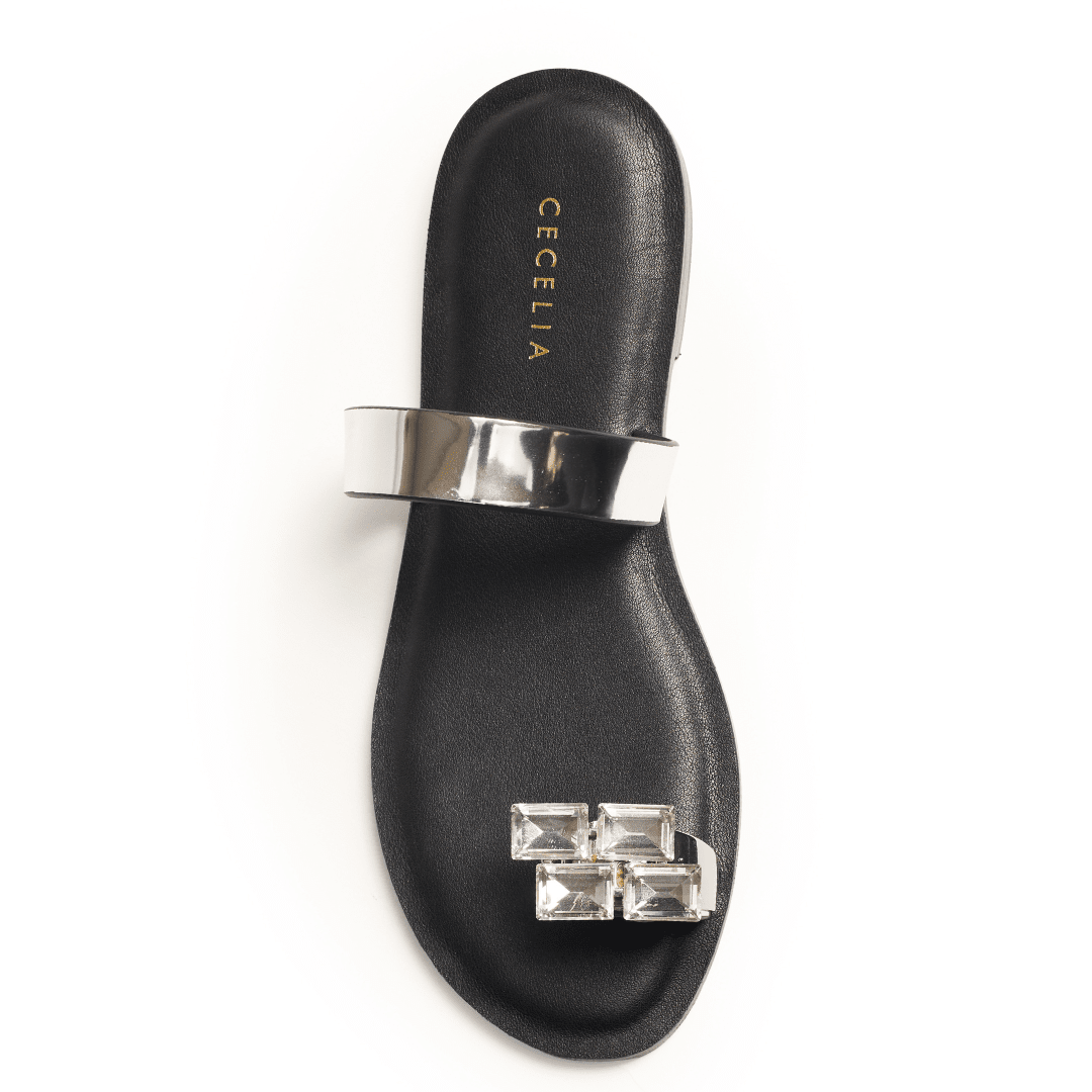 Silver metallic sandal with crystal toe detail on black footbed