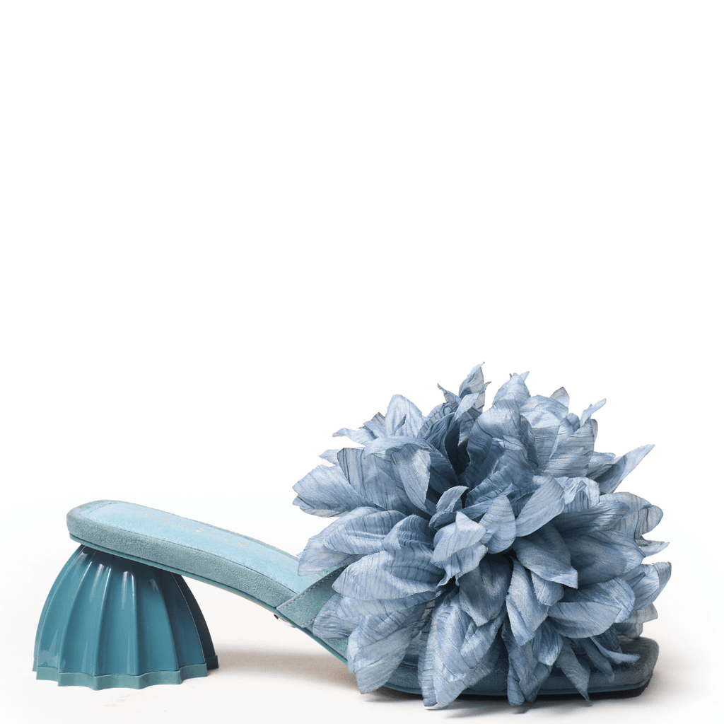 Blue slide with a large accent flower on vamp sculpture heel mid height