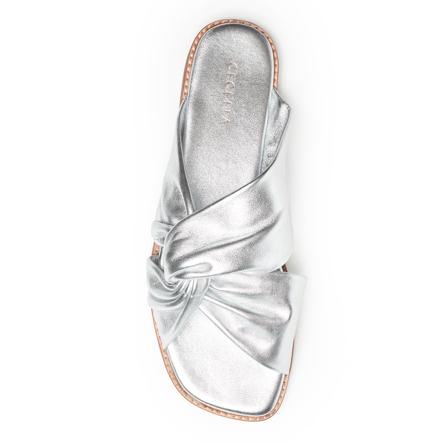 Soft Silver leather sandal with a bow on a white background