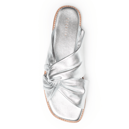 Soft Silver leather sandal with a bow on a white background