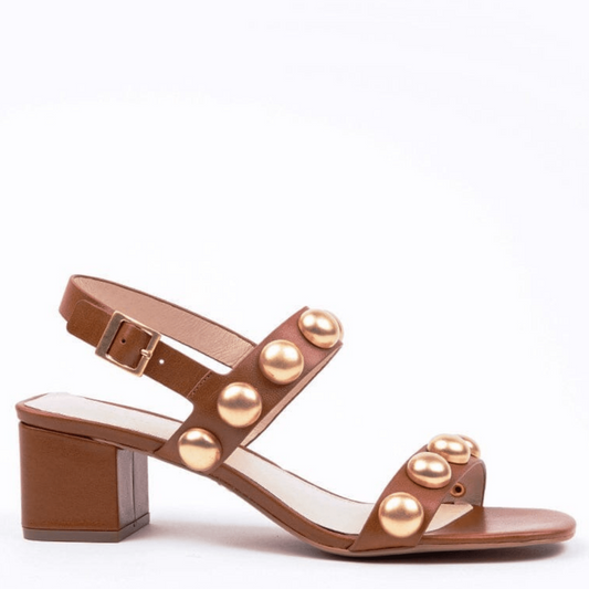 a dark tan sandal with gold dome embellishments ankle strap low heel