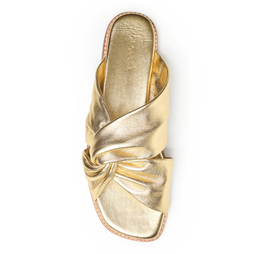 Gold sandal with a knot design flat with padded footbed