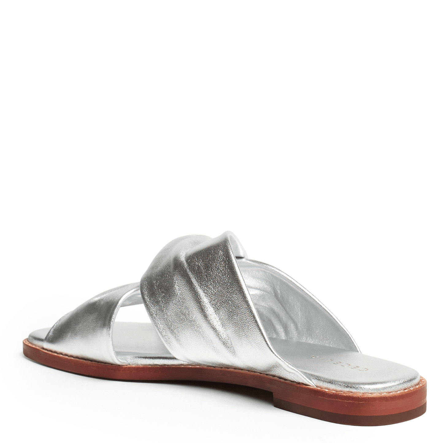 Flat Silver sandal with a brown sole on a white background