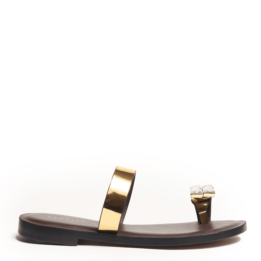Black sandal with gold strap and decorative toe element