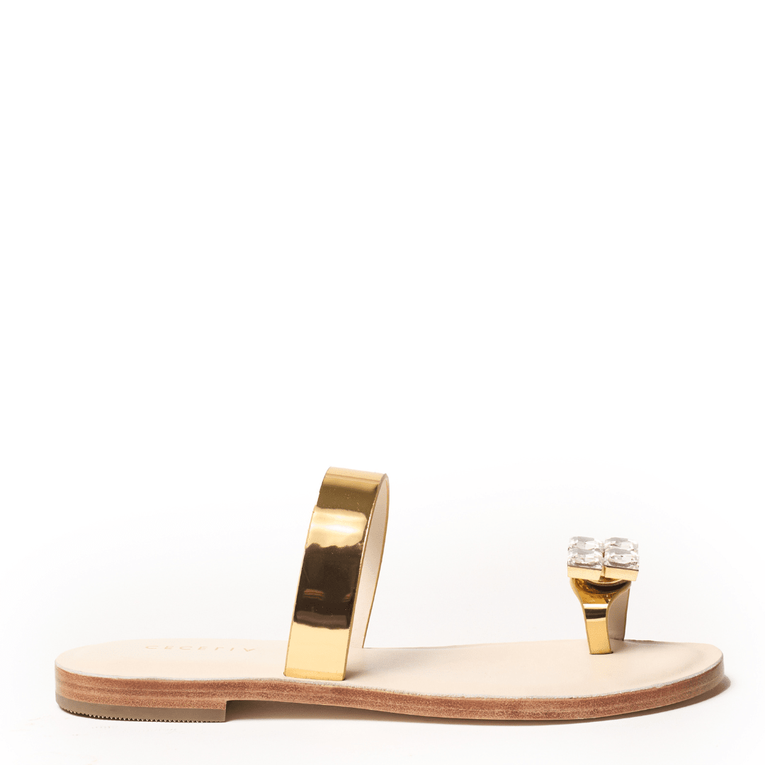Gold sandal with a minimalist design with toe detail