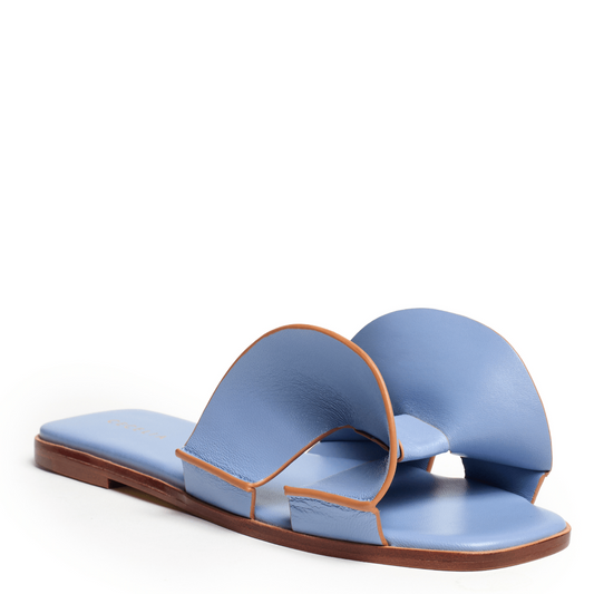 Blue sandals with brown accents on a white background