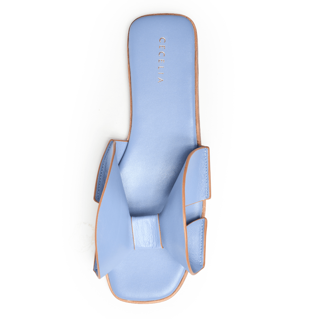 Light blue sandal with a brand name on a white background