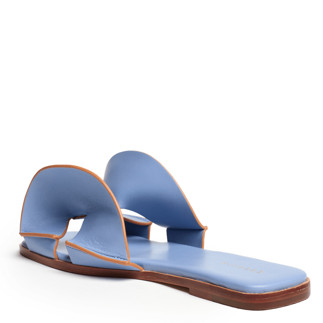 Blue sandal with brown sole on a white background