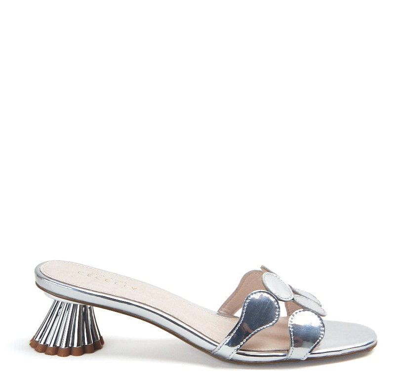 A silver metallic kitten heel sandal with a circle toe strap and a distinctive heel design.